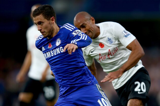 LONDON, ENGLAND - NOVEMBER 01:  Eden Hazard of Chelsea is tracked by Karl Henry of Queens Park Rangers during the Barclays Premier League match between Chelsea and Queens Park Rangers at Stamford Bridge on November 1, 2014 in London, England.  (Photo by Clive Rose/Getty Images)