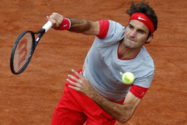 Switzerland's Roger Federer serves the ball to Latvia's Ernests Gulbis during their fourth round match of  the French Open tennis tournament at the Roland Garros stadium, in Paris, France, Sunday, June 1, 2014. (AP Photo/David Vincent)