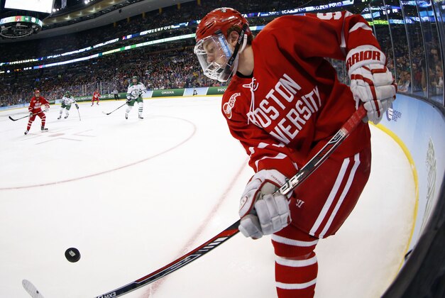Apr 9, 2015; Boston, MA, USA; Boston University forward Jack Eichel (9) tries to control the puck against North Dakota during the second period of a semifinal game in the men's Frozen Four college ice hockey tournament at TD Garden. Mandatory Credit: Winslow Townson-USA TODAY Sports