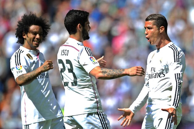 MADRID, SPAIN - APRIL 11:  Cristiano Ronaldo of Real Madrid celebrates with Isco and Marcelo after scoring Real's opening goal from a free kick during the La Liga match between Real Madrid and Eibar at Estadio Santiago Bernabeu on April 11, 2015 in Madrid, Spain.  (Photo by Denis Doyle/Getty Images)