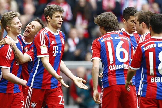 Bayern's Thomas Mueller, 3rd left, celebrates after scoring his side's third goal during the German first division Bundesliga soccer match between FC Bayern Munich and Eintracht Frankfurt in the Allianz Arena in Munich, Germany, on Saturday, April 11, 2015. (AP Photo/Matthias Schrader)