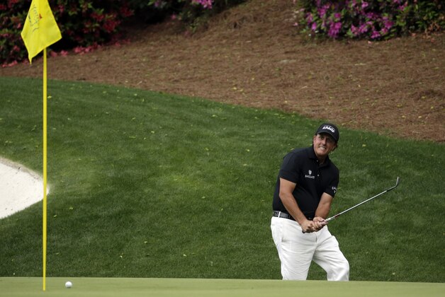 Phil Mickelson reacts after missing an eagle chip on the 13th hole during the second round of the Masters golf tournament Friday, April 10, 2015, in Augusta, Ga. (AP Photo/Chris Carlson)