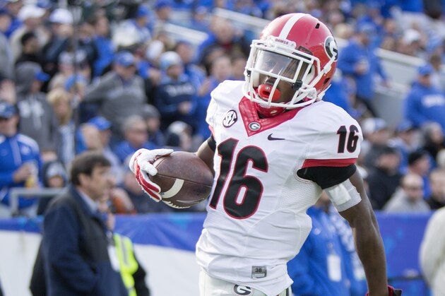 Georgia wide receiver Isaiah McKenzie scores a touchdown off a 59-yard punt return during the second half of an NCAA college football game against Kentucky at Commonwealth Stadium in Lexington, Ky., Saturday, Nov. 8, 2014. Georgia beat Kentucky 63-31. (AP Photo/David Stephenson)