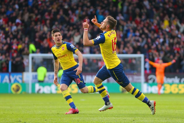 BURNLEY, ENGLAND - APRIL 11:  Aaron Ramsey of Arsenal celebrates scoring the opening goal with Hector Bellerin of Arsenal during the Barclays Premier League match between Burnley and Arsenal at Turf Moor on April 11, 2015 in Burnley, England.  (Photo by Dave Thompson/Getty Images)