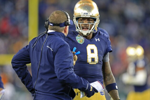 Notre Dame quarterback Malik Zaire (8) talks with coach Brian Kelly during the second half of the Music City Bowl NCAA college football game against LSU on Tuesday, Dec. 30, 2014, in Nashville, Tenn. Notre Dame beat LSU 31-28. (AP Photo/Mark Humphrey)