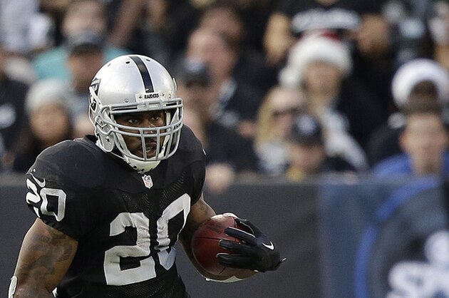 FILE - In this Dec. 21, 2014, file photo, Oakland Raiders running back Darren McFadden carries the ball during an NFL football game in Oakland, Calif. The Dallas Cowboys and McFadden agreed on a contract Friday, March, 13, 2015, a day after DeMarco Murray bolted for NFC East rival Philadelphia on a big contract that Dallas owner Jerry Jones said he couldn't match because of the strain it would have put on the salary cap.  (AP Photo/Marcio Jose Sanchez, File)