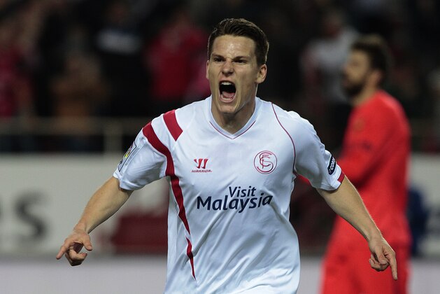 Sevilla's Kevin Gameiro from France, celebrates after scoring against Barcelona during their La Liga soccer match at the Ramon Sanchez Pizjuan stadium, in Seville, Spain on Saturday, April 11, 2015. (AP Photo/Angel Fernandez)