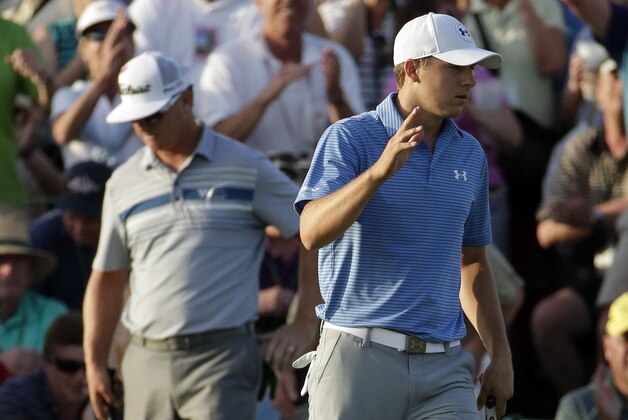 Jordan Spieth waves after putting out on the 18th hole during the third round of the Masters golf tournament Saturday, April 11, 2015, in Augusta, Ga. (AP Photo/Charlie Riedel)