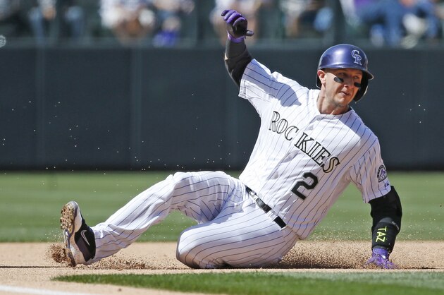 Colorado Rockies' Troy Tulowitzki slides into third against the Chicago Cubs on opening day Friday, April 10, 2015, in Denver. (AP Photo/Jack Dempsey)