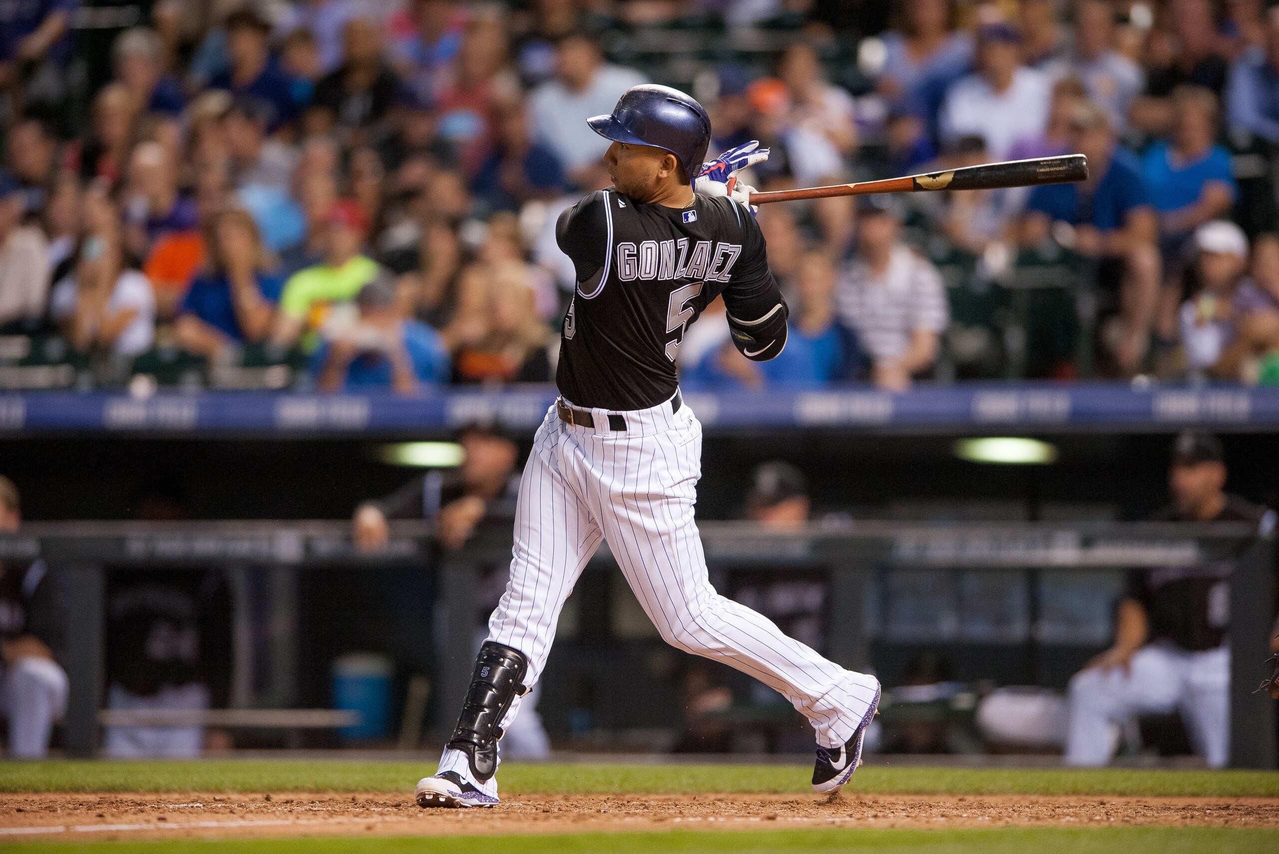 DENVER, CO - AUGUST 06:  Carlos Gonzalez #5 of the Colorado Rockies hits a two run home run in the sixth inning of a game against the Chicago Cubs at Coors Field on August 6, 2014 in Denver, Colorado.  (Photo by Dustin Bradford/Getty Images)