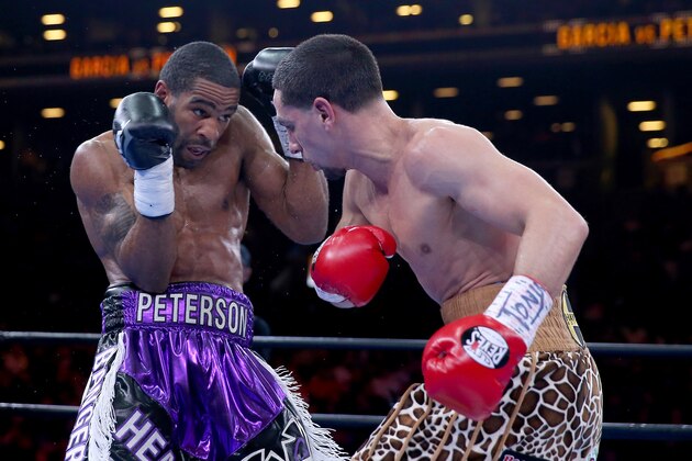NEW YORK, NY - APRIL 11:  Danny Garcia and  Lamont Peterson exchange blows during the Premier Boxing Champions Middleweight bout at Barclays Center on April 11, 2015 in the Brooklyn borough of  New York City.  (Photo by Elsa/Getty Images)