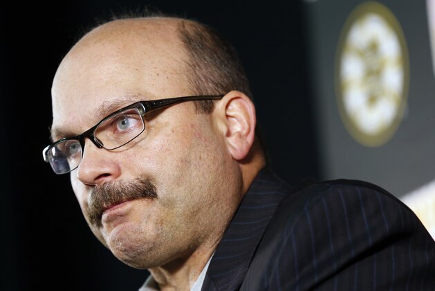 Boston Bruins general manager Peter Chiarelli talks to reporters during a news conference before a preseason NHL hockey game against the Detroit Red Wings in Boston, Saturday, Oct. 4, 2014. The Bruins announced the trade of Johnny Boychuk to the New York Islanders on Saturday. (AP Photo/Michael Dwyer)