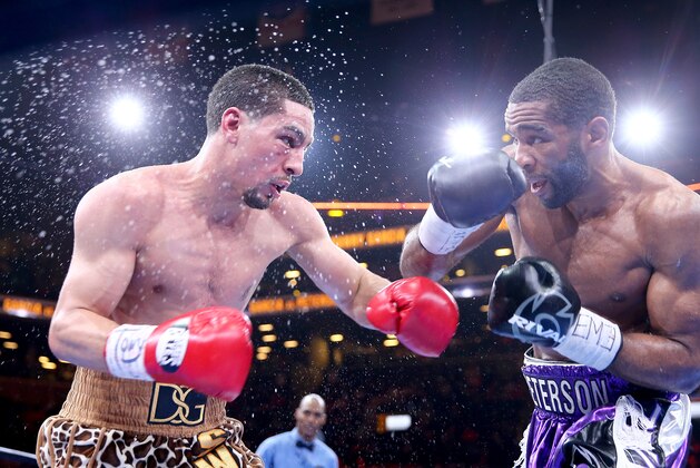 NEW YORK, NY - APRIL 11:  Danny Garcia and  Lamont Peterson exchange punches during the Premier Boxing Champions Middleweight bout at Barclays Center on April 11, 2015 in the Brooklyn borough of  New York City.  (Photo by Elsa/Getty Images)