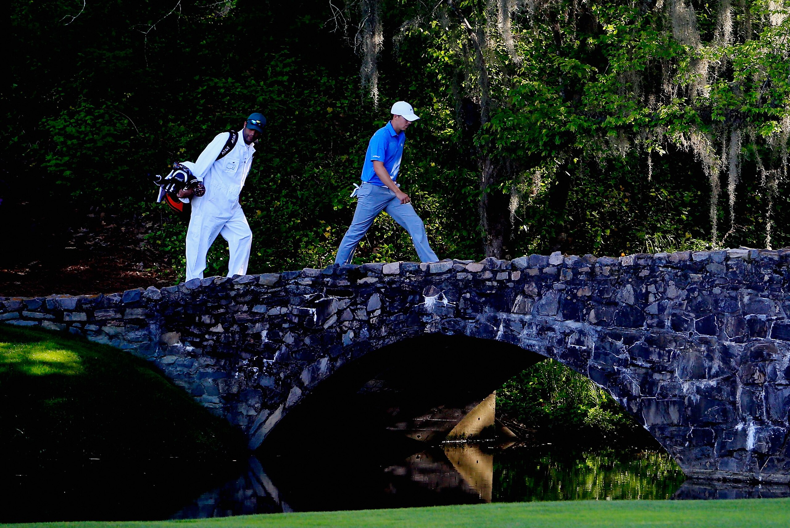 AUGUSTA, GA - APRIL 11:  Jordan Spieth of the United States and his caddie Michael Greller walk over the Nelson Bridge on the 13th hole during the third round of the 2015 Masters Tournament at Augusta National Golf Club on April 11, 2015 in Augusta, Georgia.  (Photo by Jamie Squire/Getty Images)