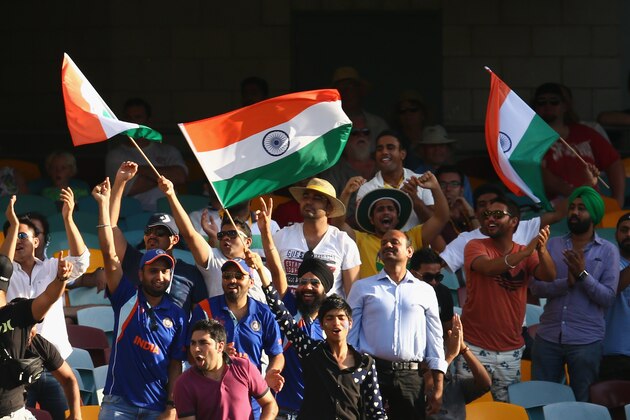 BRISBANE, AUSTRALIA - DECEMBER 17: Indian fans celebrate a boundary during day one of the 2nd Test match between Australia and India at The Gabba on December 17, 2014 in Brisbane, Australia.  (Photo by Cameron Spencer/Getty Images)