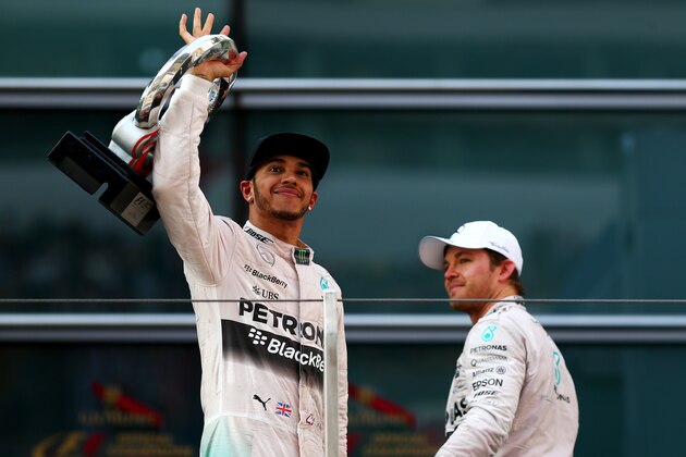 SHANGHAI, CHINA - APRIL 12:  Lewis Hamilton of Great Britain and Mercedes GP celebrates on the podium next to Nico Rosberg of Germany and Mercedes GP after winning the Formula One Grand Prix of China at Shanghai International Circuit on April 12, 2015 in Shanghai, China.  (Photo by Dan Istitene/Getty Images)