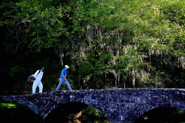 AUGUSTA, GA - APRIL 11:  Jordan Spieth of the United States and his caddie Michael Greller walk over the Nelson Bridge on the 13th hole during the third round of the 2015 Masters Tournament at Augusta National Golf Club on April 11, 2015 in Augusta, Georgia.  (Photo by Jamie Squire/Getty Images)