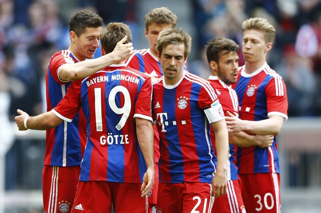 Bayern's Robert Lewandowski from Poland, left, celebrates with teammates after scoring his side's second goal during the German first division Bundesliga soccer match between FC Bayern Munich and Eintracht Frankfurt in the Allianz Arena in Munich, Germany, on Saturday, April 11, 2015. (AP Photo/Matthias Schrader)