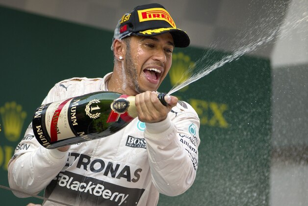 Mercedes driver Lewis Hamilton of Britain sprays champagne from the podium after winning the Chinese Formula One Grand Prix at Shanghai International Circuit in Shanghai, China, Sunday, April 12, 2015. (AP Photo/Mark Schiefelbein)