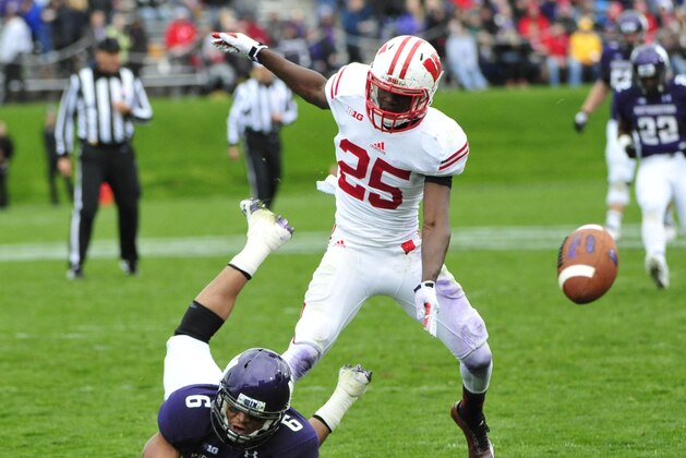 EVANSTON, IL- OCTOBER 04: Tony Jones #6 of the Northwestern Wildcats is defended by Derrick Tindal #25 of the Wisconsin Badgers during the first half on October 4, 2014 at Ryan Field in Evanston, Illinois.  (Photo by David Banks/Getty Images)