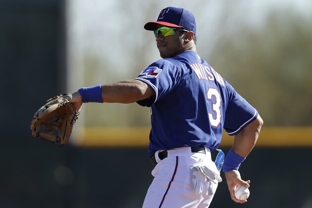 SURPRISE, AZ - MARCH 03: Russell Wilson #3 of the Texas Rangers throws in the outfield during a work out before the game against the Cleveland Indians at Surprise Stadium on March 03, 2014 in Surprise, Arizona. (Photo by Mike McGinnis/Getty Images)