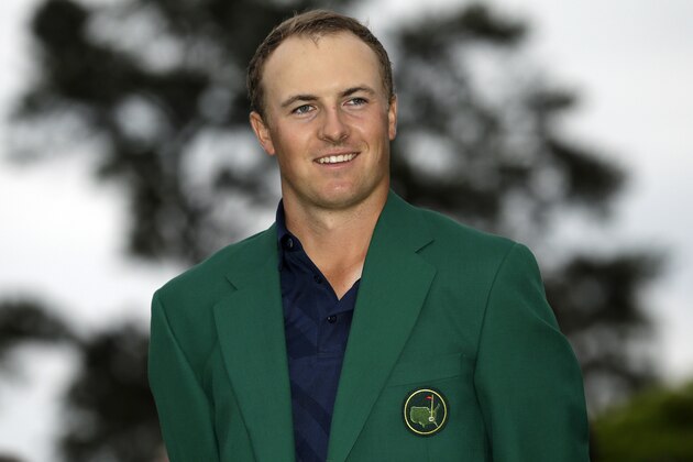 Jordan Spieth poses with his green jacket after winning the Masters golf tournament Sunday, April 12, 2015, in Augusta, Ga. (AP Photo/David J. Phillip)