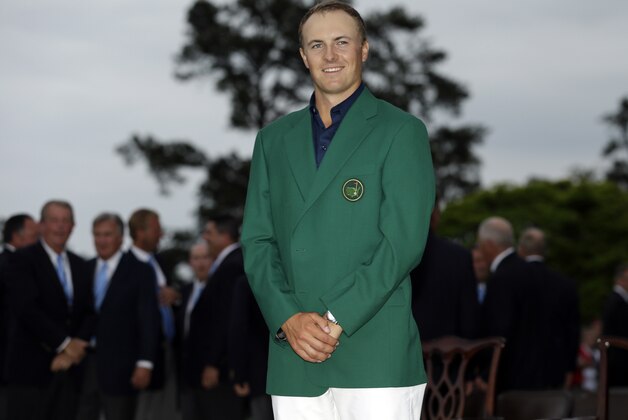 Jordan Spieth poses with his green jacket after winning the Masters golf tournament Sunday, April 12, 2015, in Augusta, Ga. (AP Photo/David J. Phillip)