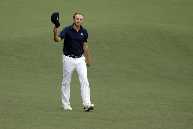 Jordan Spieth waves to the gallery as he walks up the 18th fairway during the fourth round of the Masters golf tournament Sunday, April 12, 2015, in Augusta, Ga. (AP Photo/Matt Slocum)