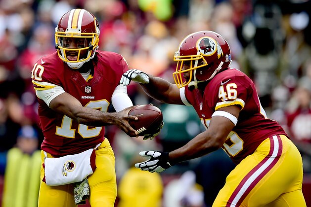 LANDOVER, MD - NOVEMBER 16:  Quarterback Robert Griffin III #10 of the Washington Redskins hands off to running back Alfred Morris #46 during the first quarter of a game against the Tampa Bay Buccaneers at FedExField on November 16, 2014 in Landover, Maryland.  (Photo by Patrick McDermott/Getty Images)