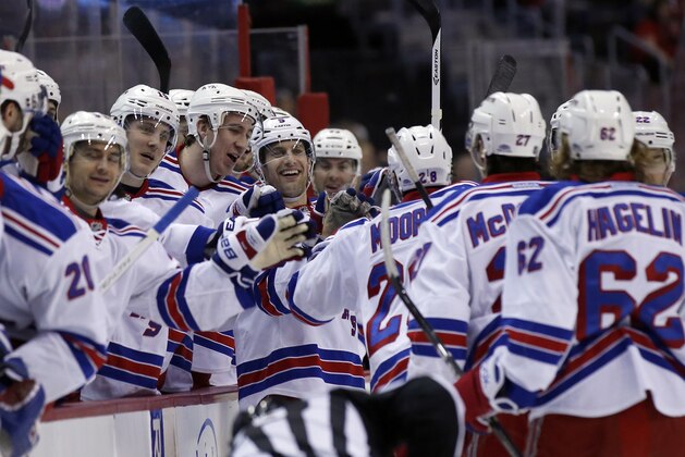 New York Rangers center Dominic Moore (28) celebrates his goal with his teammates in the second period of an NHL hockey game against the Washington Capitals, Saturday, April 11, 2015, in Washington. (AP Photo/Alex Brandon)