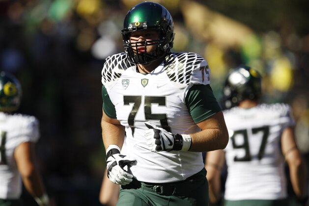 Oregon offensive lineman Jake Fisher warms up before facing Colorado in the first quarter of an NCAA college football game in Boulder, Colo., on Saturday, Oct. 5, 2013. (AP Photo/David Zalubowski)