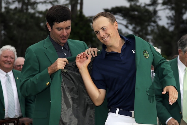 Bubba Watson helps Jordan Spieth put on his green jacket after winning the Masters golf tournament Sunday, April 12, 2015, in Augusta, Ga. (AP Photo/Matt Slocum)