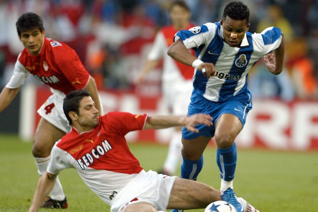 Andreas Zikos of Monaco, left, challenges Carlos Alberto of Porto during the UEFA Champions League Final between AS Monaco and  FC Porto in the 'Arena AufSchalke' in Gelsenkirchen, Germany, Wednesday, May 26, 2004. (AP Photo/Frank Augstein)