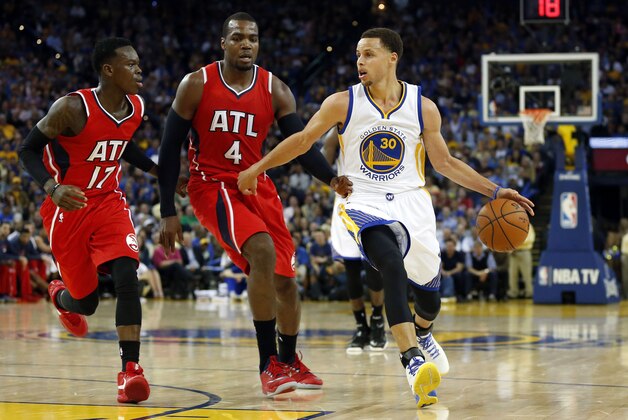 Mar 18, 2015; Oakland, CA, USA; Golden State Warriors guard Stephen Curry (30) brings the ball down the court around Atlanta Hawks forward Paul Millsap (4) and Hawks guard Dennis Schroder (17) during the fourth quarter at Oracle Arena. Mandatory Credit: Bob Stanton-USA TODAY Sports