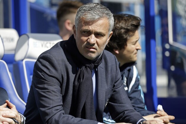 Chelsea's Chelsea manager Jose Mourinho takes his seat on the bench before the English Premier League soccer match between QPR and Chelsea at Loftus Road stadium in London, Sunday, April 12, 2015. (AP Photo/Matt Dunham)