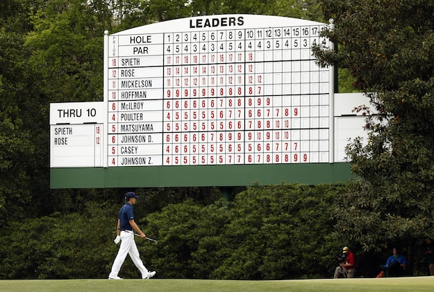 Apr 12, 2015; Augusta, GA, USA; Jordan Spieth walks past a leaderboard to the 11th green during the final round of The Masters golf tournament at Augusta National Golf Club. Mandatory Credit: Rob Schumacher-USA TODAY Sports