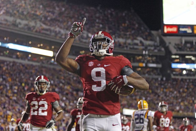 FILE - In this Nov. 8, 2014, file photo, Alabama wide receiver Amari Cooper (9) celebrates his 23-yard touchdown reception in the first half of an NCAA college football game against LSU in Baton Rouge, La. Cooper has been Alabama's biggest offensive weapon by far, and one of the nation's most prolific receivers. Now, he's trying to become just the third receiver to win a Heisman Trophy.  (AP Photo/Jonathan Bachman, File)