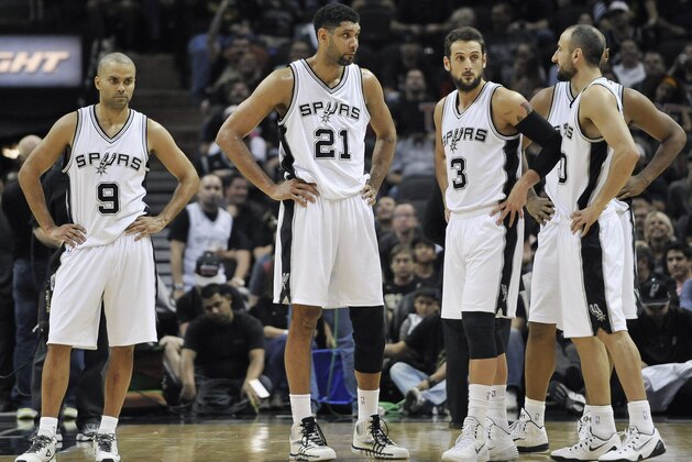 San Antonio Spurs's Tony Parker,  Tim Duncan, Marco Belinelli and Manu Ginobili stand on the court during the second half of an NBA basketball game against the Oklahoma City Thunder, Wednesday, March 25, 2015, in San Antonio. San Antonio won 130-91. (AP Photo/Darren Abate)