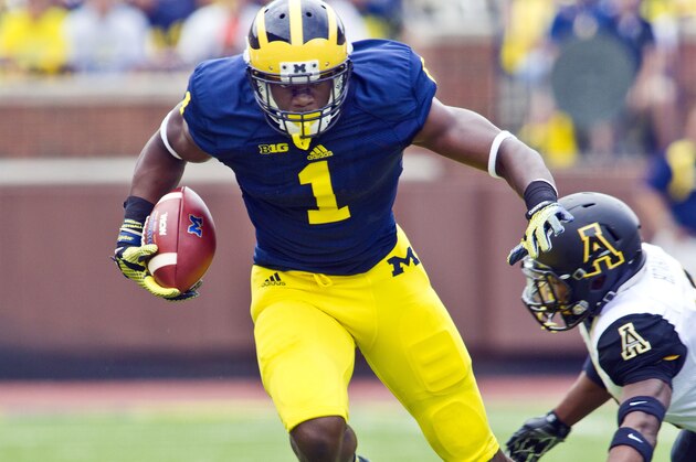 Michigan wide receiver Devin Funchess (1) breaks away from Appalachian State defensive back A.J. Howard, bottom, in the first quarter of  an NCAA college football game in Ann Arbor, Mich., Saturday, Aug. 30, 2014. (AP Photo/Tony Ding)