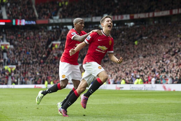 Manchester United's Abder Herrera, centre, celebrates with teammate Ashley Young after scoring during the English Premier League soccer match between Manchester United and Aston Villa  at Old Trafford Stadium, Manchester, England, Saturday, April 4, 2015. (AP Photo/Jon Super)