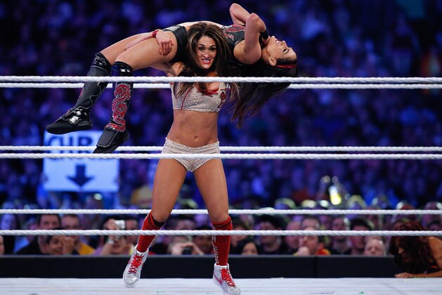 Brie Bella and Nikki Bella, known as the Bella Twins, compete during Wrestlemania XXX at the Mercedes-Benz Super Dome in New Orleans on Sunday, April 6, 2014. (Jonathan Bachman/AP Images for WWE)