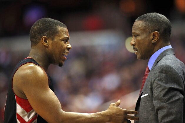 Toronto Raptors guard Kyle Lowry (7) and head coach Dwane Casey talk in the first half of an NBA basketball game against the Washington Wizards, Saturday, Jan. 31, 2015, in Washington. (AP Photo/Alex Brandon)