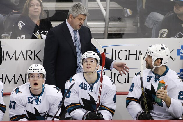 San Jose Sharks head coach Todd McLellan talks with John Scott (20) in the third period of an NHL hockey game against the Pittsburgh Penguins in Pittsburgh Sunday, March 29, 2015. The Penguins won in a shootout 3-2. (AP Photo/Gene J. Puskar)