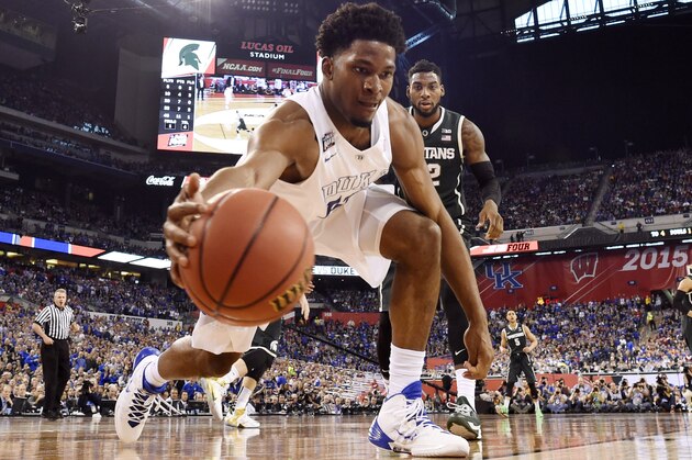Apr 4, 2015; Indianapolis, IN, USA; Duke Blue Devils forward Justise Winslow (12) dives to try to save a ball from going out of bounds as Michigan State Spartans guard/forward Branden Dawson (22) looks on in the second half of the 2015 NCAA Men's Division I Championship semi-final game at Lucas Oil Stadium. Mandatory Credit: Bob Donnan-USA TODAY Sports