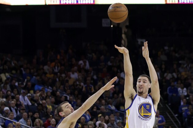 Golden State Warriors' Klay Thompson (11) shoots over Memphis Grizzlies' Marc Gasol during the second half of an NBA basketball game Monday, April 13, 2015, in Oakland, Calif. (AP Photo/Marcio Jose Sanchez)