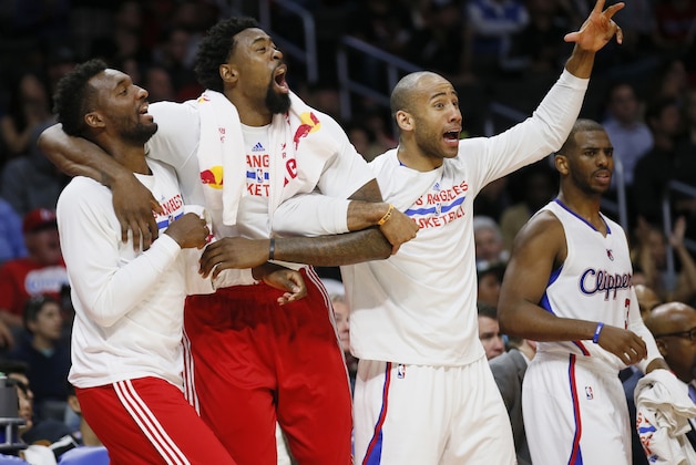 Los Angeles Clippers' Jordan Hamilton, DeAndre Jordan and Dahntay Jones, from left, celebrate while Chris Paul stands nearby after teammate Austin Rivers dunked against the Denver Nuggets during the second half of an NBA basketball game, Monday, April 13, 2015, in Los Angeles. The Clippers won 110-103. (AP Photo/Danny Moloshok)