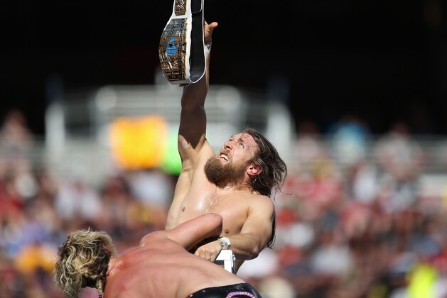 Daniel Bryan reaches for the championship belt at Wrestlemania XXXI, on Sunday, March 29, 2015 in Santa Clara, CA. 2015 marks the first year Wrestlemania will be held in the San Francisco Bay Area, being made available to viewers in 177 countries via the WWE Network. (Don Feria/AP Images for WWE)