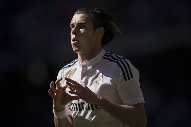 Real Madrid's Gareth Bale celebrates after scoring a goal during a La Liga soccer match between Real Madrid and Granada at the Santiago Bernabeu stadium in Madrid, Spain, Sunday, April 5, 2015. (AP Photo/Daniel Ochoa de Olza)