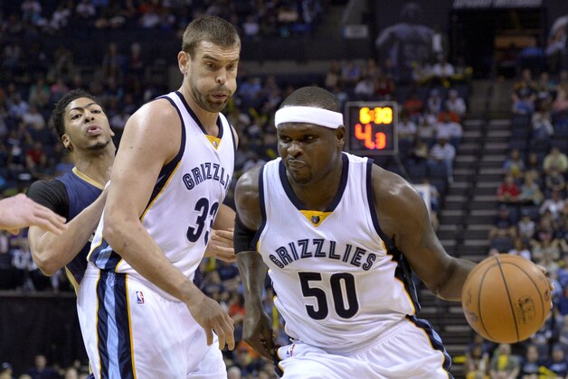 Memphis Grizzlies forward Zach Randolph (50) drives past New Orleans Pelicans forward Anthony Davis, rear, with help from Grizzlies center Marc Gasol during the first half of an NBA basketball game Wednesday, April 8, 2015, in Memphis, Tenn. (AP Photo/Brandon Dill)