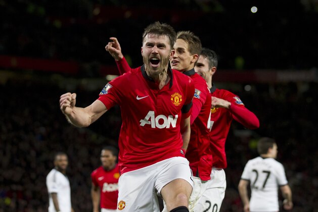 Manchester United's Michael Carrick, centre, celebrates with teammates after scoring against Fulham during their English Premier League soccer match at Old Trafford Stadium, Manchester, England, Sunday Feb. 9, 2014. (AP Photo/Jon Super)